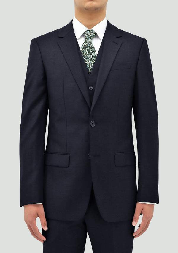 a model wears the boston michel lyon mens suit in a deep navy blue colour