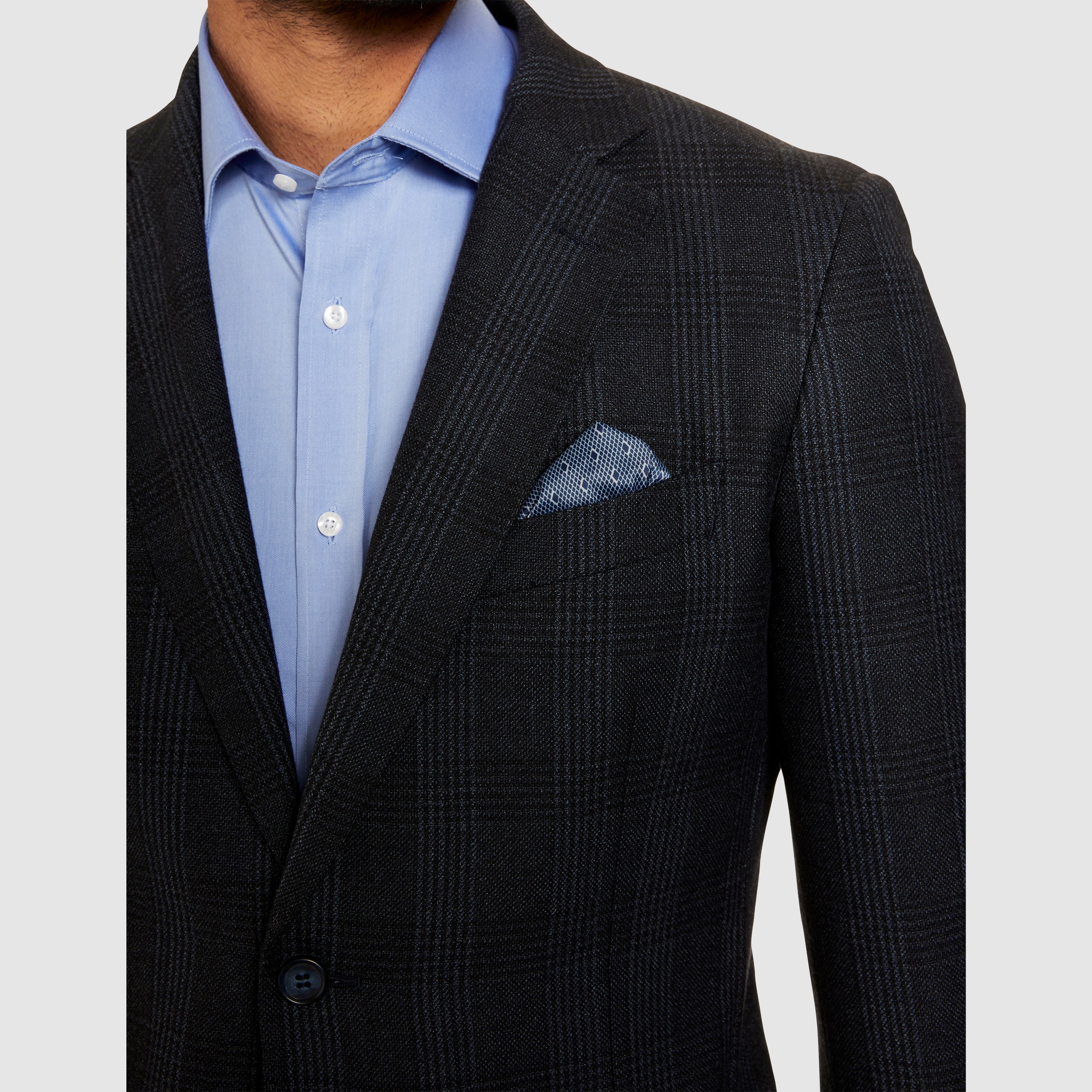 sports jacket in dark navy over a light blue cotton shirt with a printed pocketchielf, creating a smart casual mens look