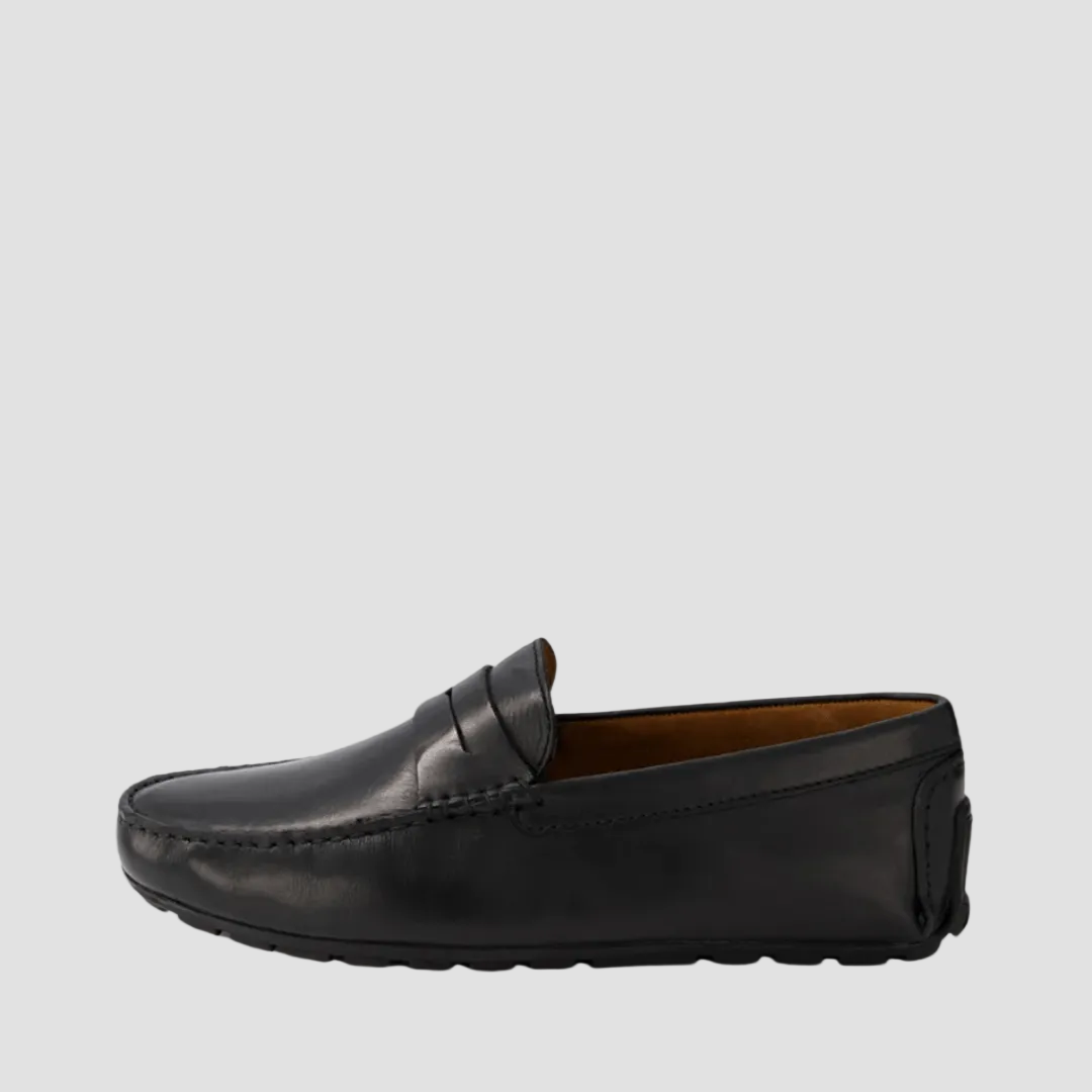 A black leather loafer with a round toe and penny strap, on a white background.