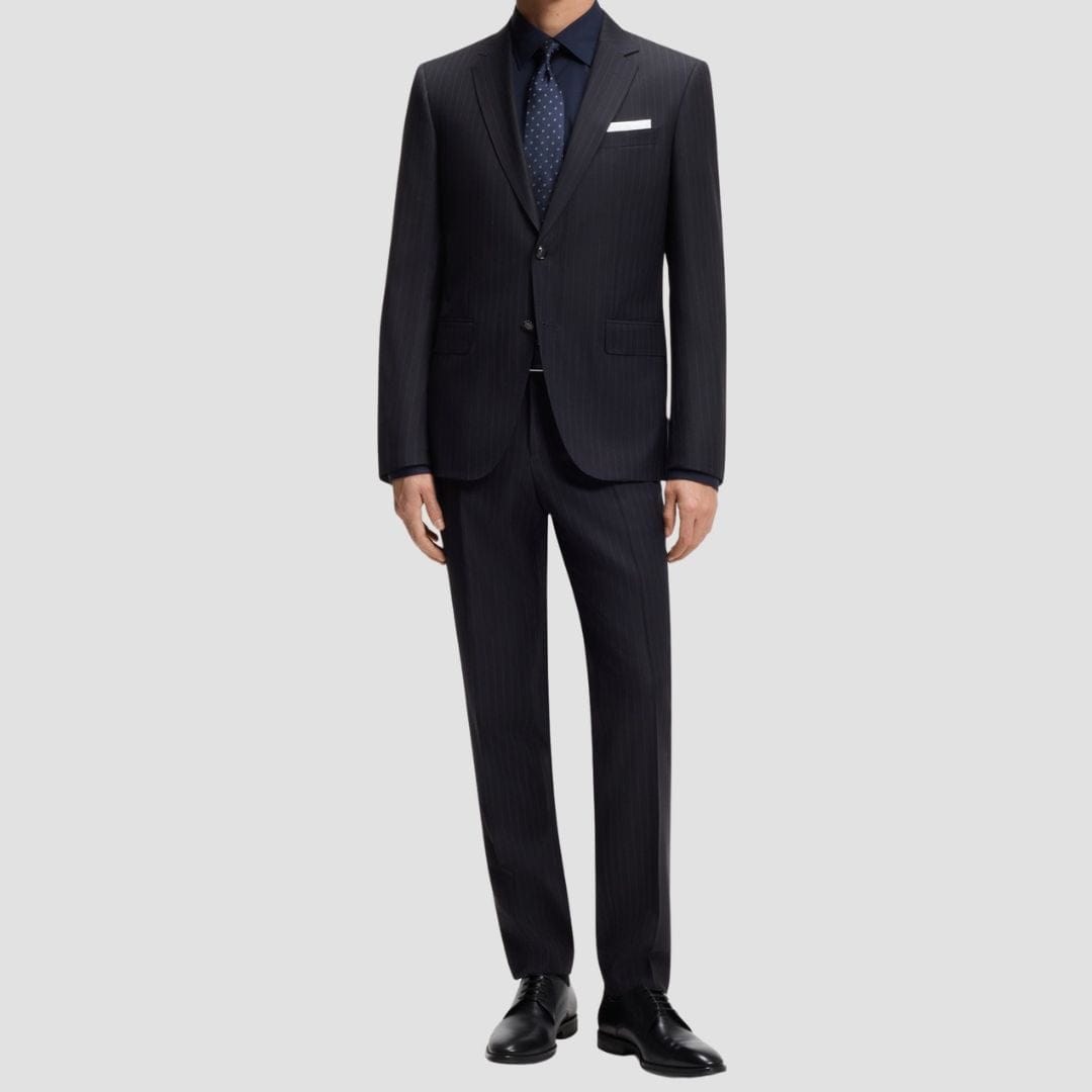 Black suit with a white shirt and patterned tie