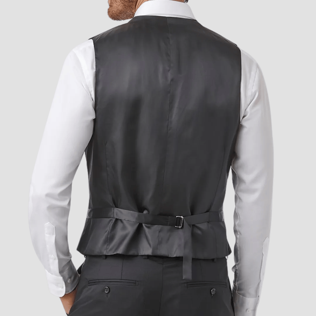 Person wearing a black vest over a white shirt with satin adjustable belt