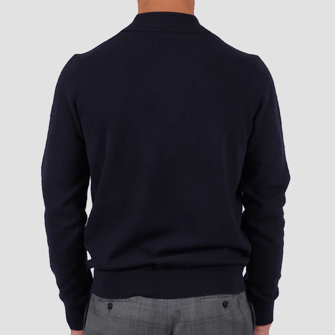Person wearing a dark blue sweater and gray pants on a transparent background