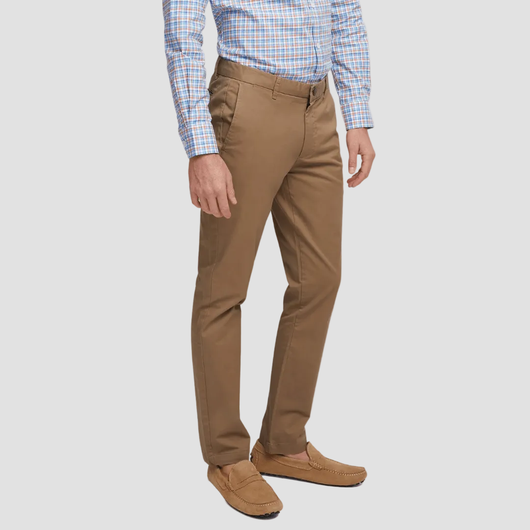 Person wearing brown pants and a checkered shirt on a light gray background