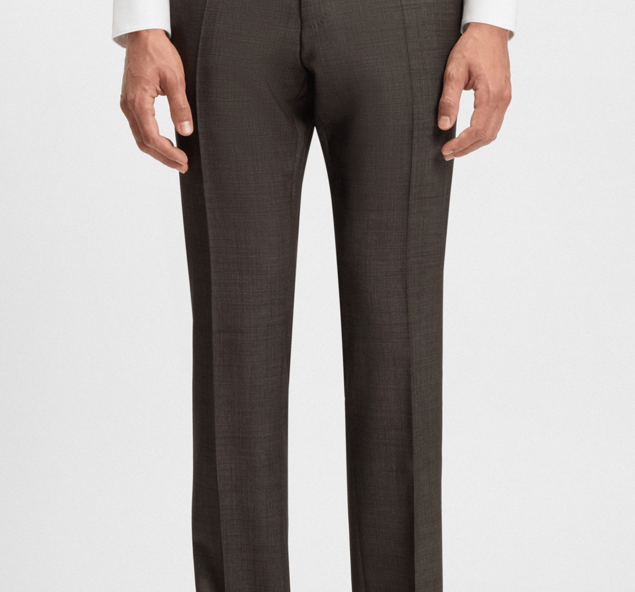 Brown suit pants with a white shirt on a light gray background