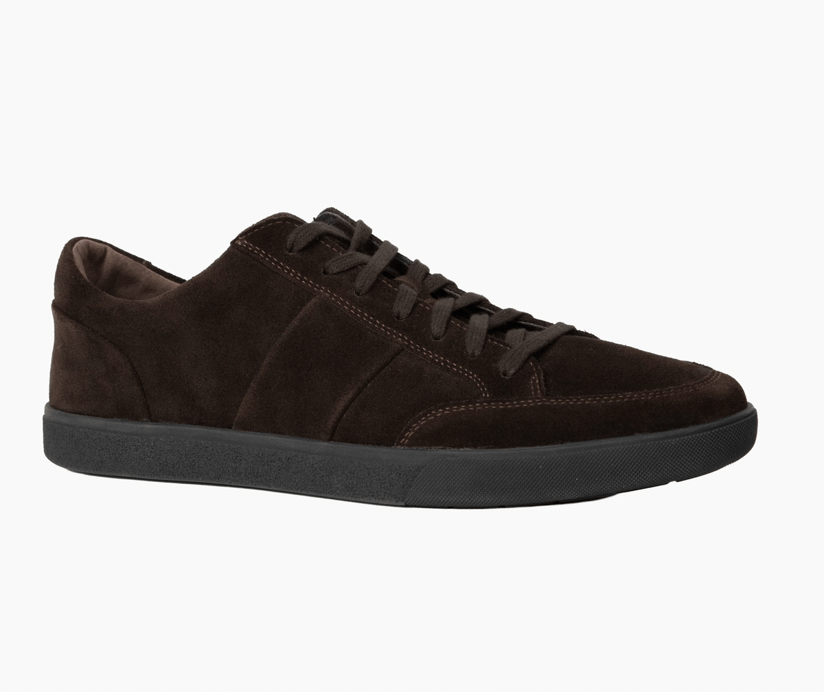 A black mid-top skate shoe shown in a side profile view against a plain white background.