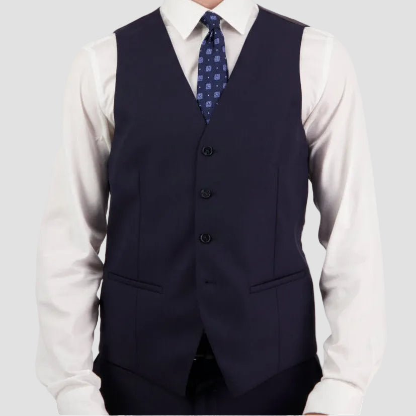 Navy vest by Savile Row over a white shirt with a patterned tie