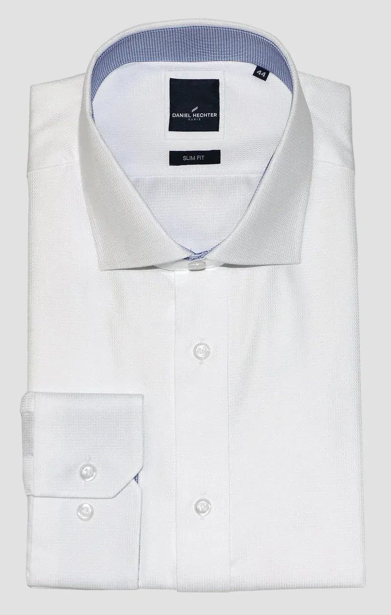 A folded white dress shirt with a pointed collar and buttoned cuffs, shown on a plain white background. The inner collar lining is light blue, and the brand label reads 'Richard Sharp'.