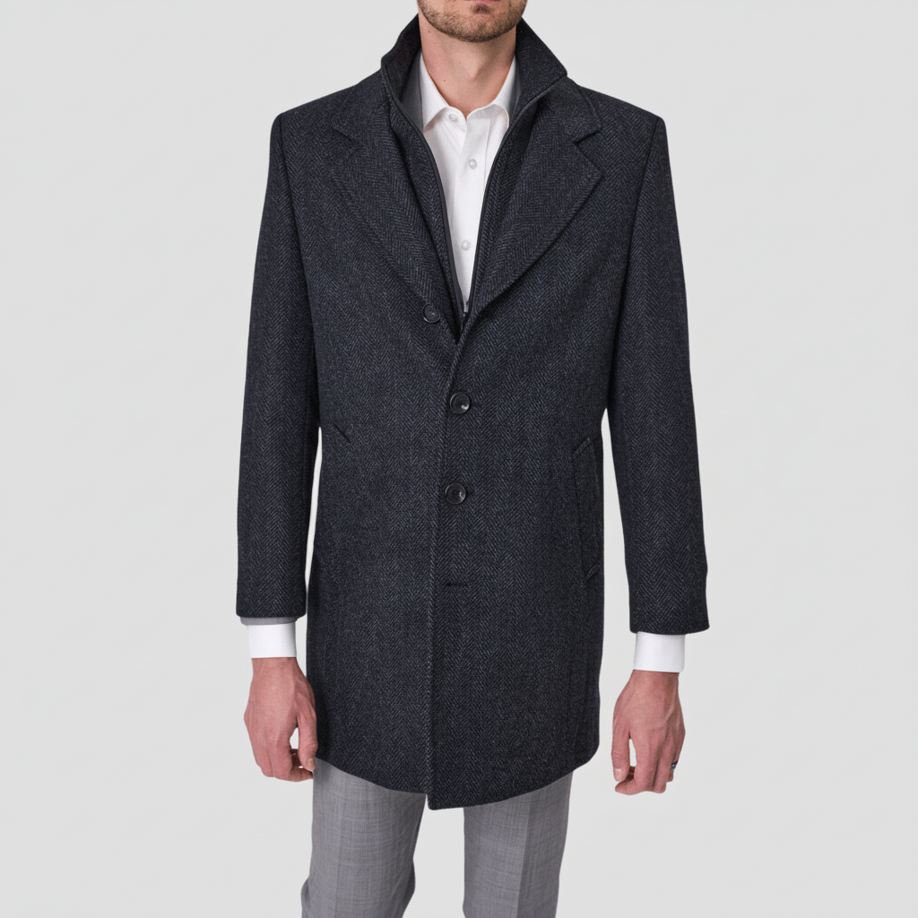 A man wearing an ash navy pure wool coat with a removable collar, single breasted, four button front, and inner zip fastening.