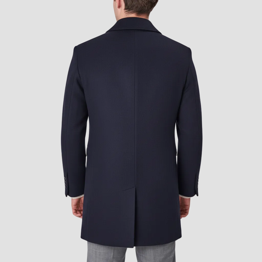 A navy blue, single-breasted, four-button front Savile Row coat with a removable collar, and a single vent at the back.