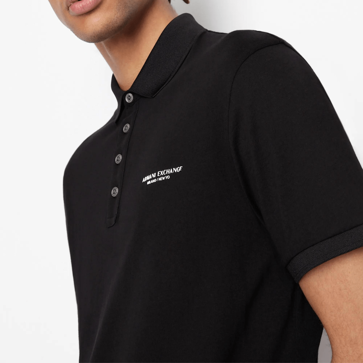 A closer look at the front detail of the black polo shirt by Armani