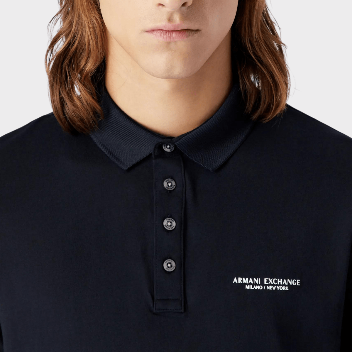 A closer look at the button and collar details of the Armani's men polo shirt in navy.
