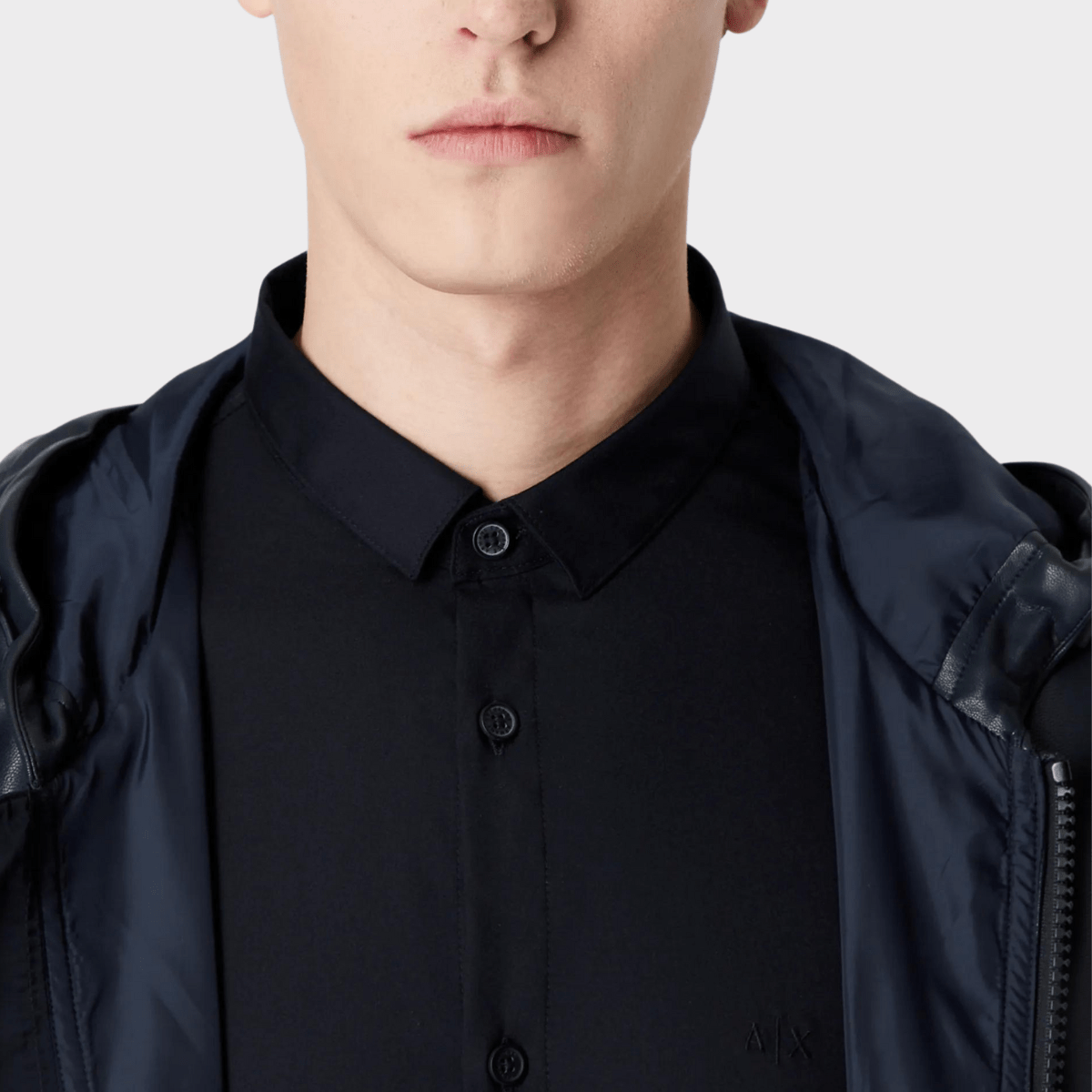 Collar and button details of the slim-fitted cotton shirt in black by Armani