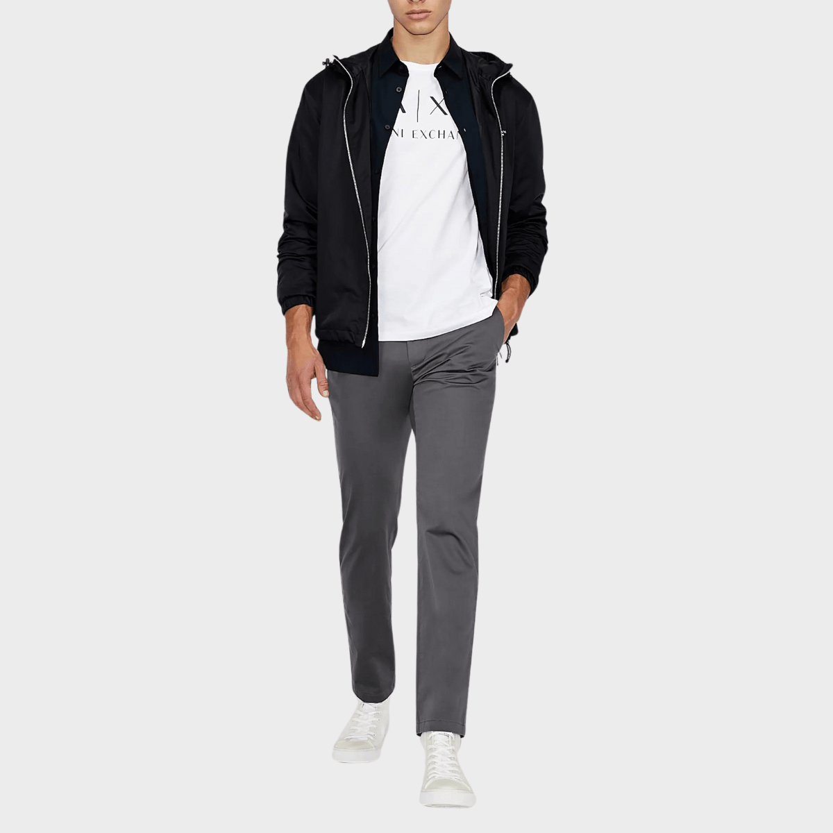 The slim-fitted cotton shirt in white by Armani styled with a black jacket.