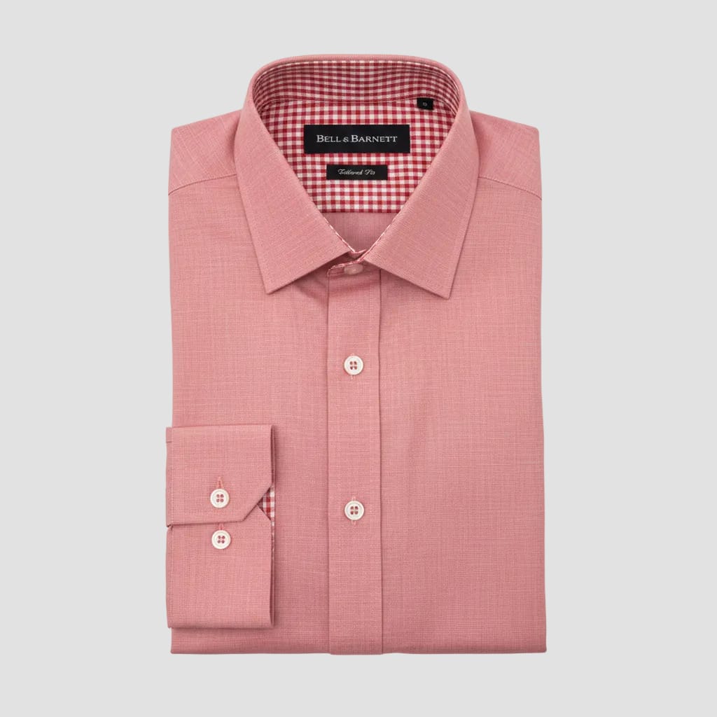 Red dress shirt with a tag on a clear plastic bag