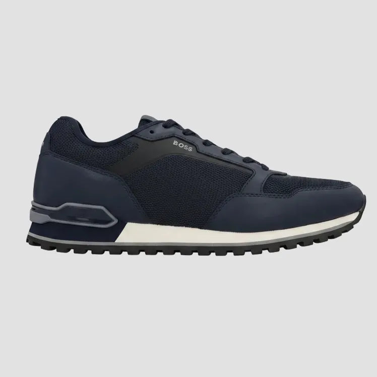 A low-top leather sneaker in off-white, featuring a matching rubber toe cap, laces, and a small embossed square logo on the side panel, set against a plain white background.