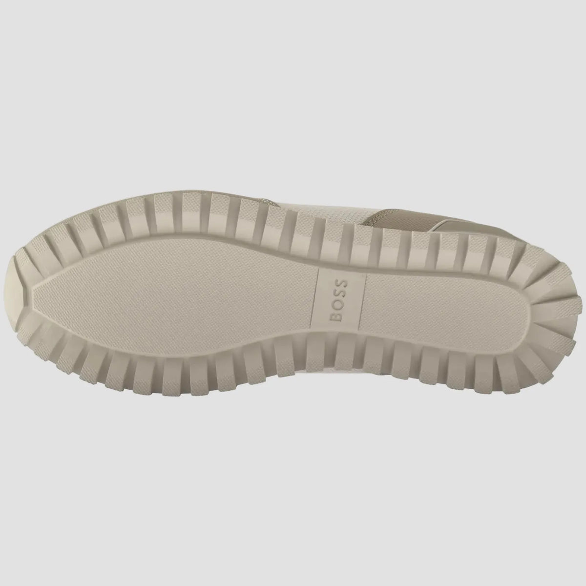 The beige rubber outsole of a slip-on shoe, featuring a textured tread pattern and the BOSS brand name embossed in the center, shown against a plain white background.