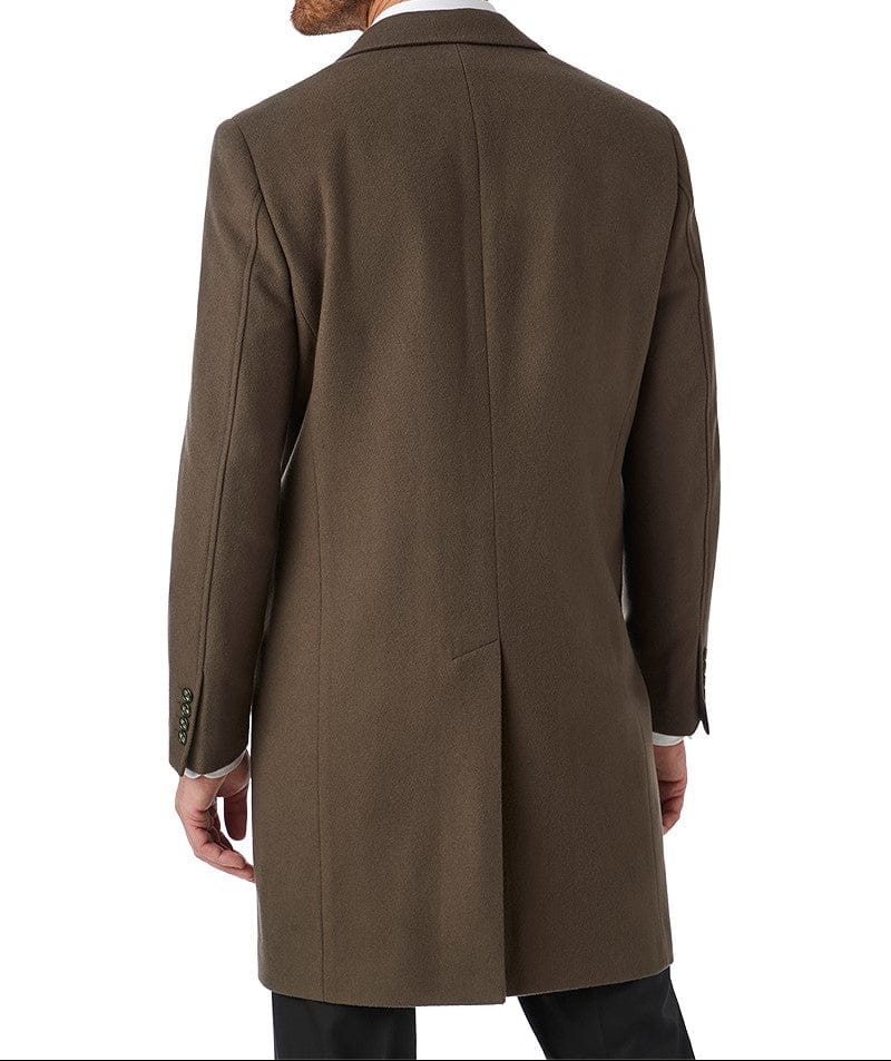Man wearing a brown overcoat on a white background