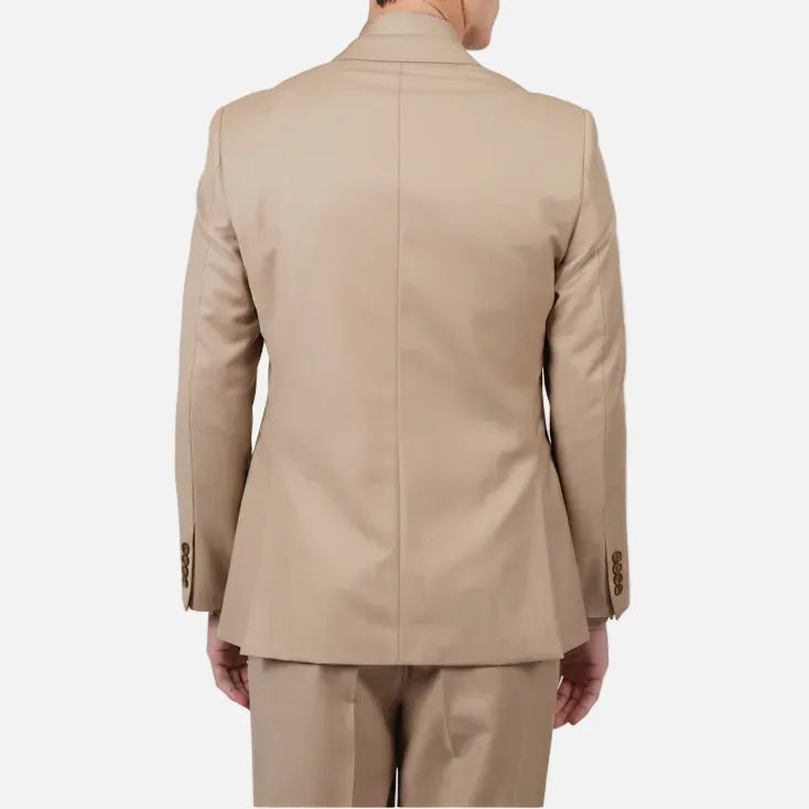 A man viewed from the back wearing a light beige suit, including a blazer and trousers, against a plain white studio background.