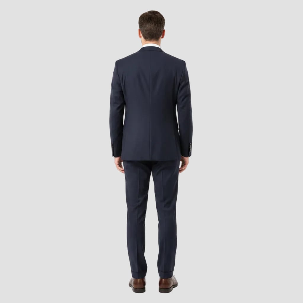Man wearing a navy suit on a light gray background