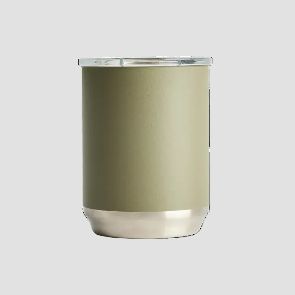 A matte sage green insulated tumbler with a brushed silver metal base and a clear lid, shown on a clean white background.