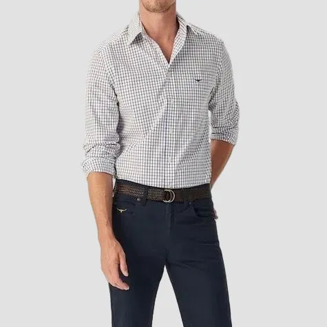 Man wearing a checkered shirt and navy pants on a white background