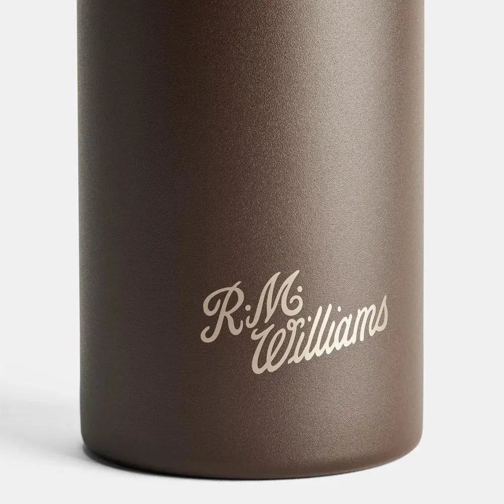 Close-up of a dark brown insulated bottle with a matte finish and the 'R.M.