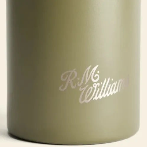 Close-up of a matte olive green insulated bottle with the name 'R.M.