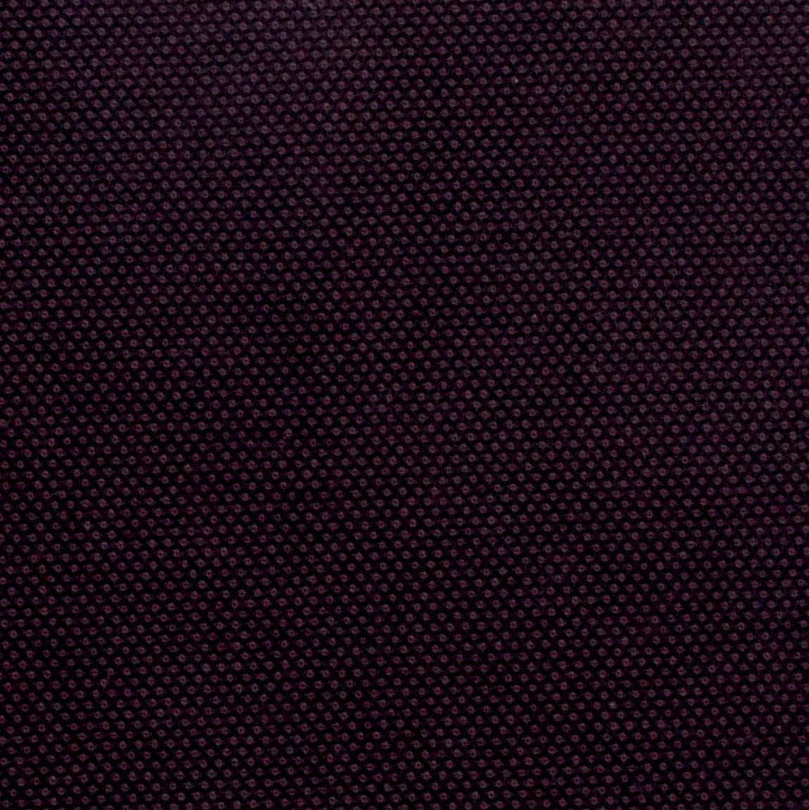 A close-up of a dark purple woven fabric texture with a fine, repeating dot pattern.