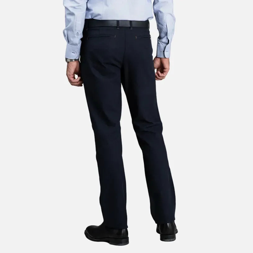 Person wearing navy pants and a light blue shirt on a gray background