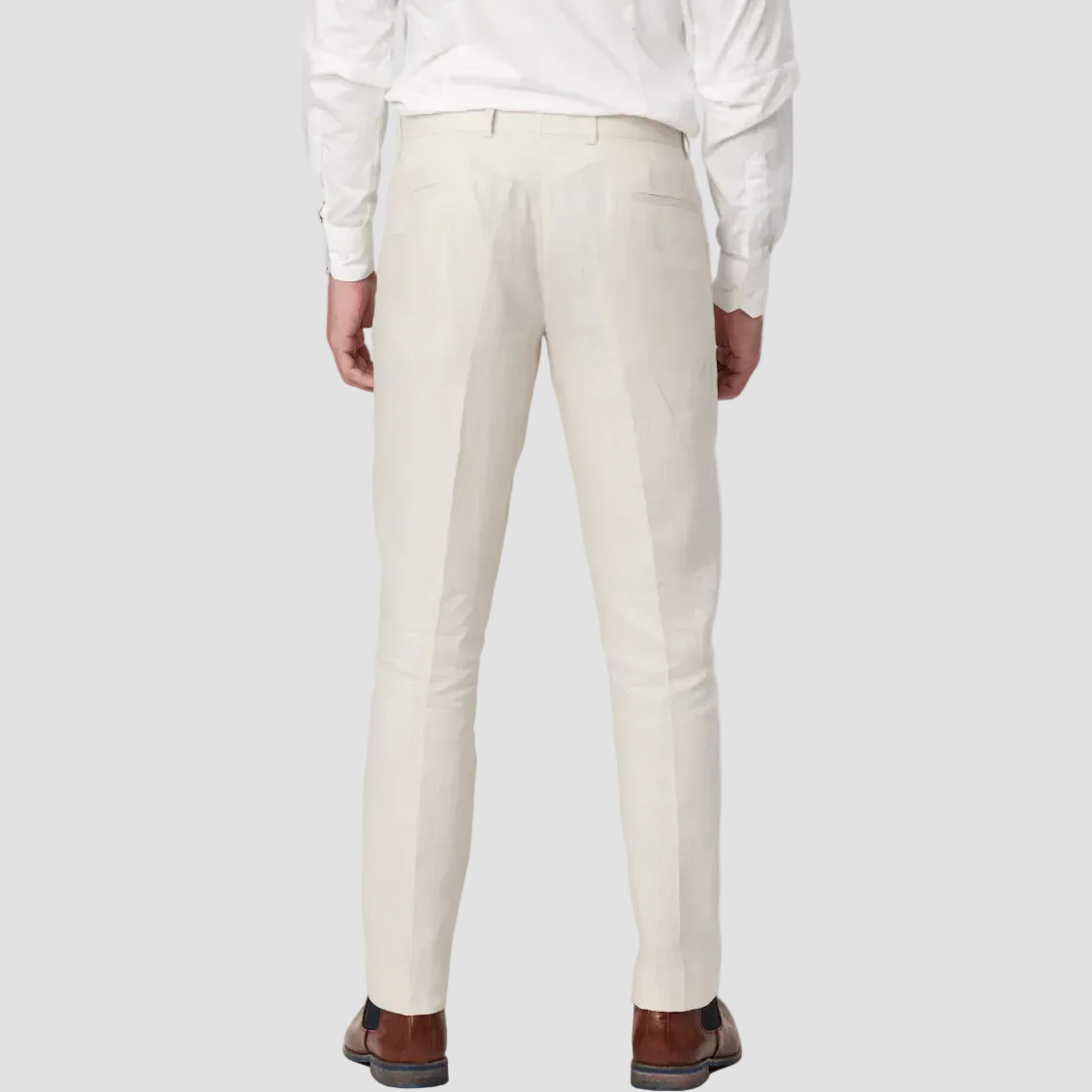 Pure linen pants in Ecru by Savile Row with a white shirt, green patterned tie and brown leather shoes.