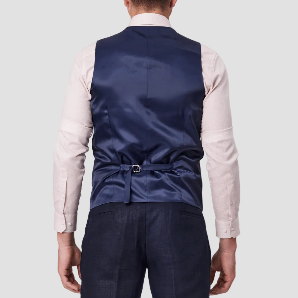 A man wearing a navy linen tailored fit vest, satin backing with an adjustable tab.