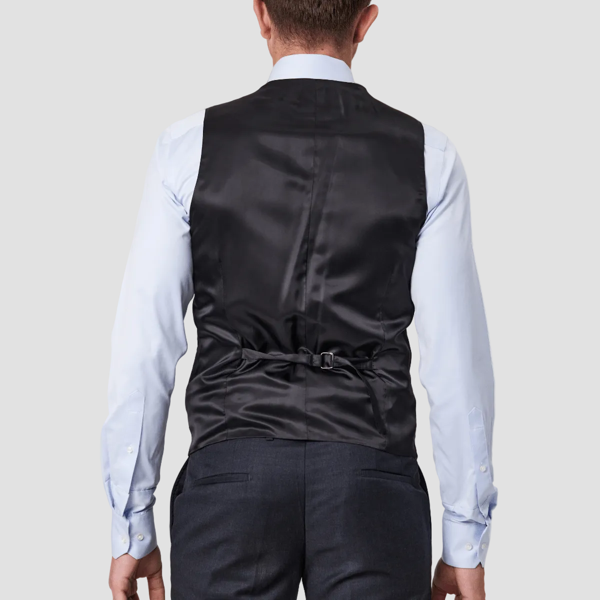 Tailored fit charcoal wool vest by Savile Row with a satin back and adjustable belt, paired with matching trousers.
