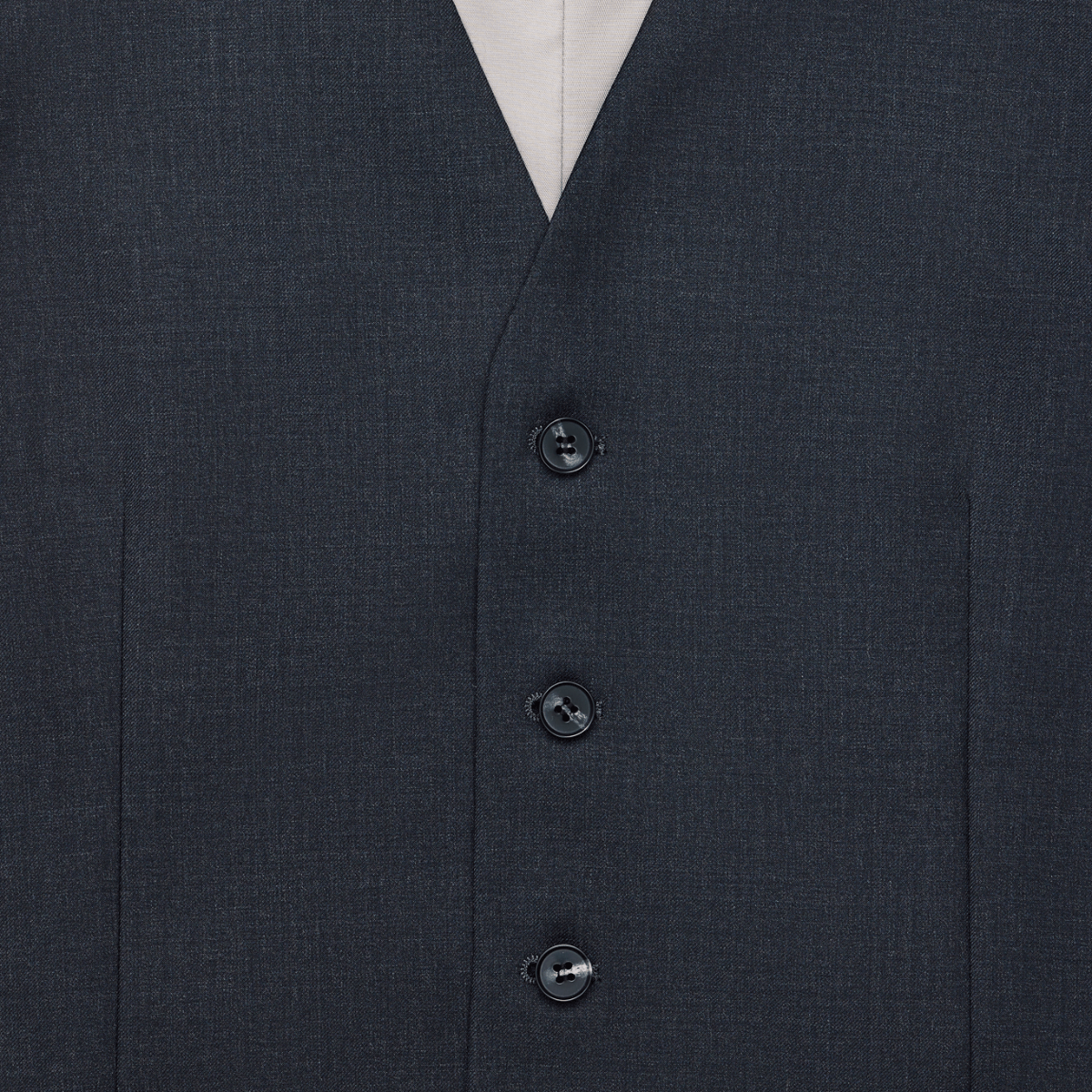 Close up of a tailored fit charcoal wool vest by Savile Row with a four-button front.
