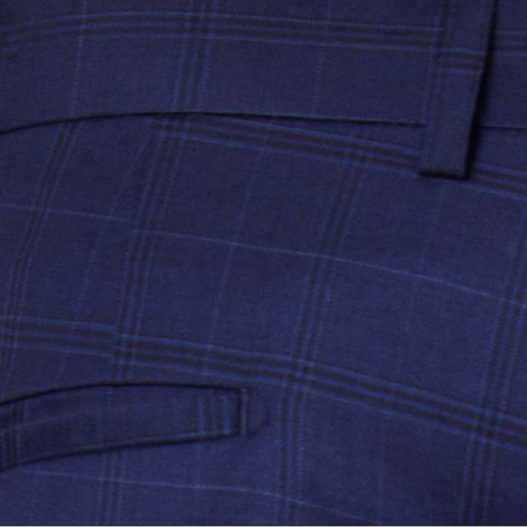 Close-up of blue plaid fabric with a focus on texture and pattern from Slim fit Jesse suit trousers in navy by Savile Row.