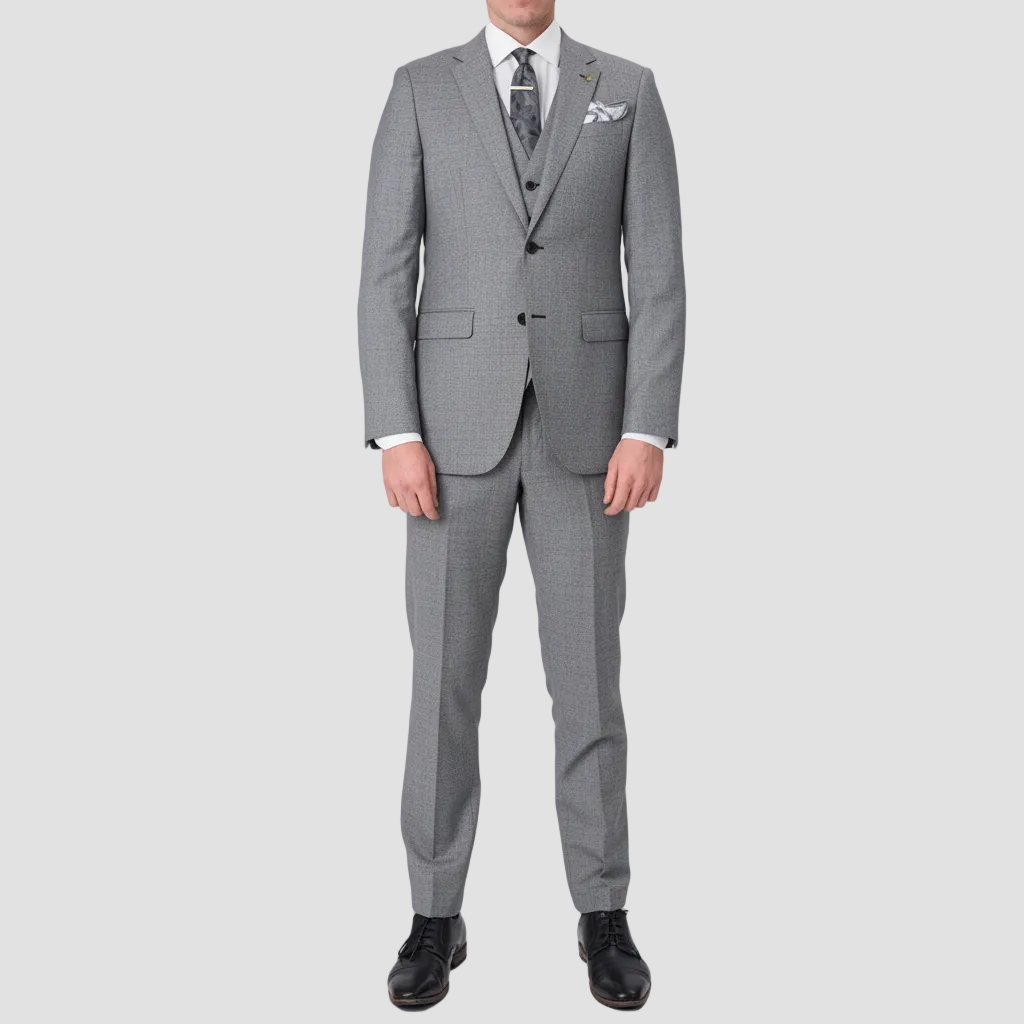 Chrome Australian merino wool textured suit by Savile Row with a silver tie with black patterns, a white pocket square with grey edges and black leather shoes.