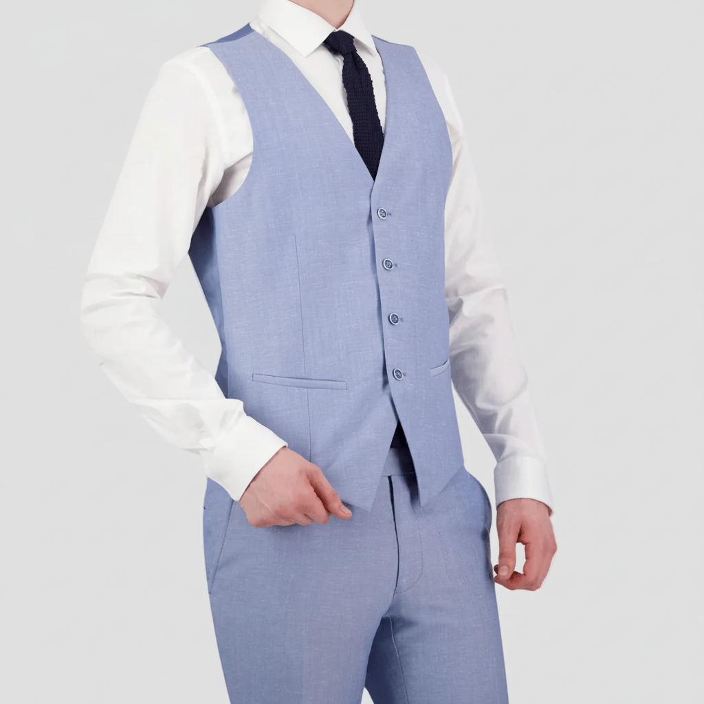 A man wearing a sky blue Savile Row tailored fit men's vest with a four button front, paired with a white shirt and a dark tie.
