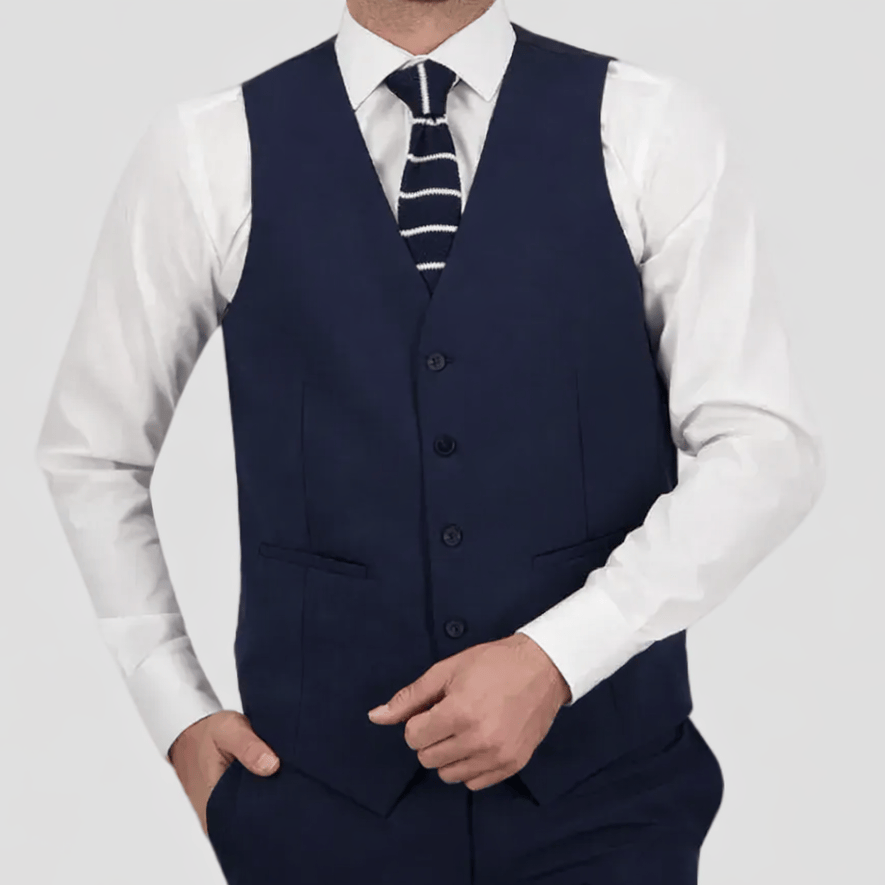 The Navy Saul Survivor Vest—tailored fit, four‑button front, and satin back.