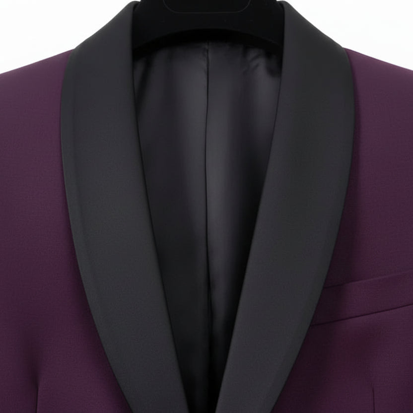 A close-up of a men's formal jacket featuring a purple body and contrasting black satin shawl lapels, with a matching burgundy satin inner lining.