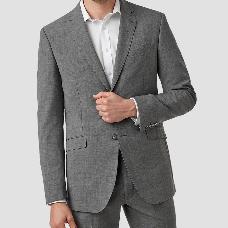 Man wearing a gray suit jacket and pants on a white background