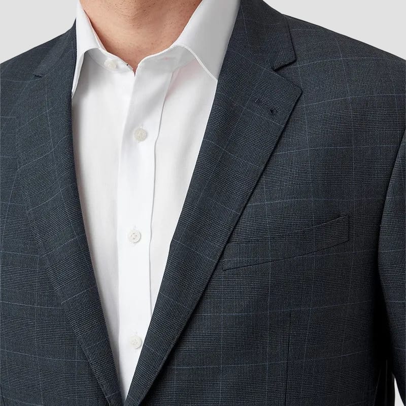Man wearing a dark navy checkered suit jacket over a white shirt