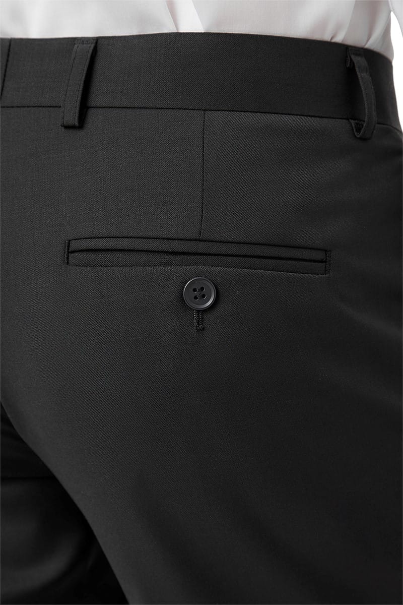 Close-up of black pants with a button on a white background