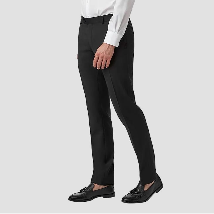 Man wearing a white dress shirt and black pants on a white background