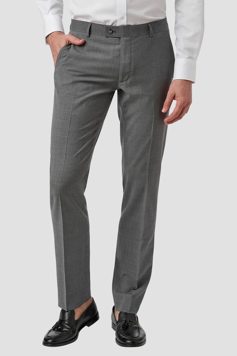 Gray dress pants worn by a person on a white background