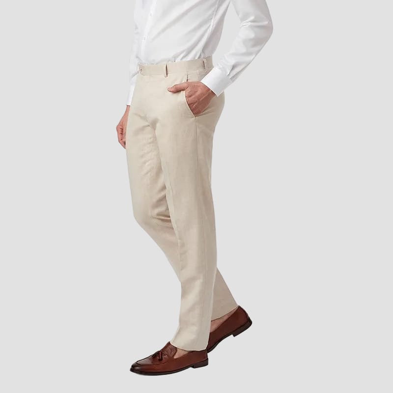 Man wearing a white dress shirt and beige pants on a white background