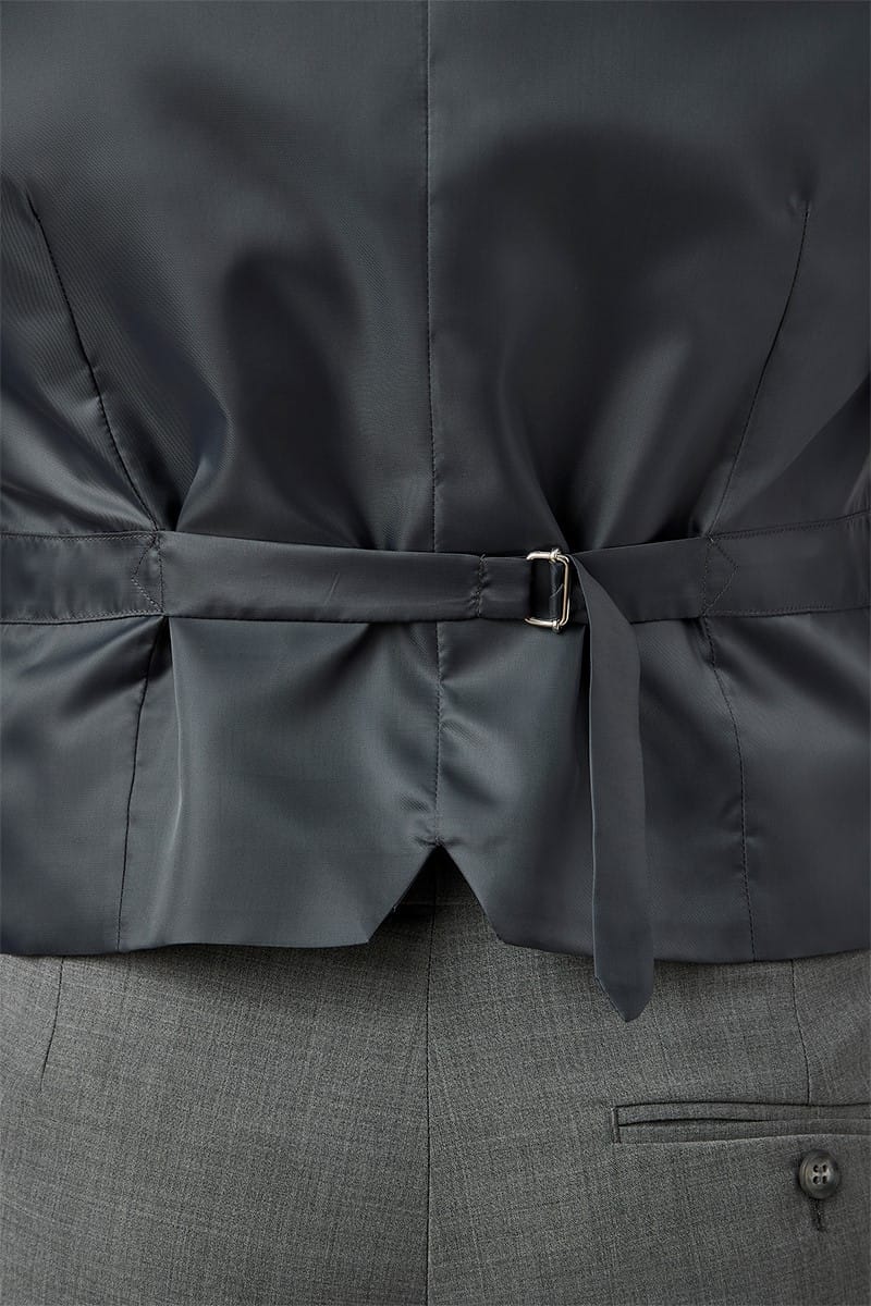 Close-up of a dark gray jacket with a belt and gray pants.