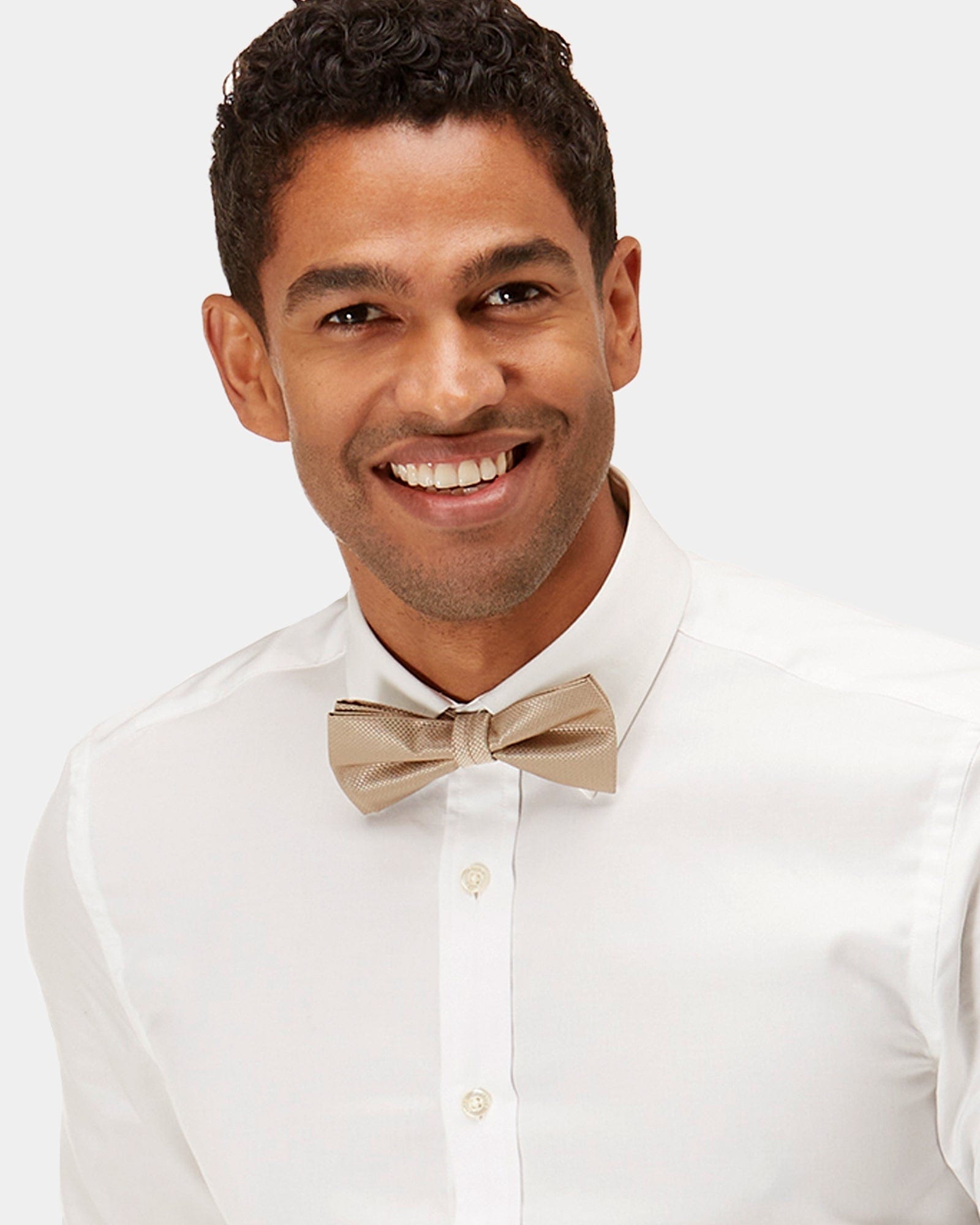 close up of the mens dress shirt the wedding shirt by brooksfield with a gold bow tie