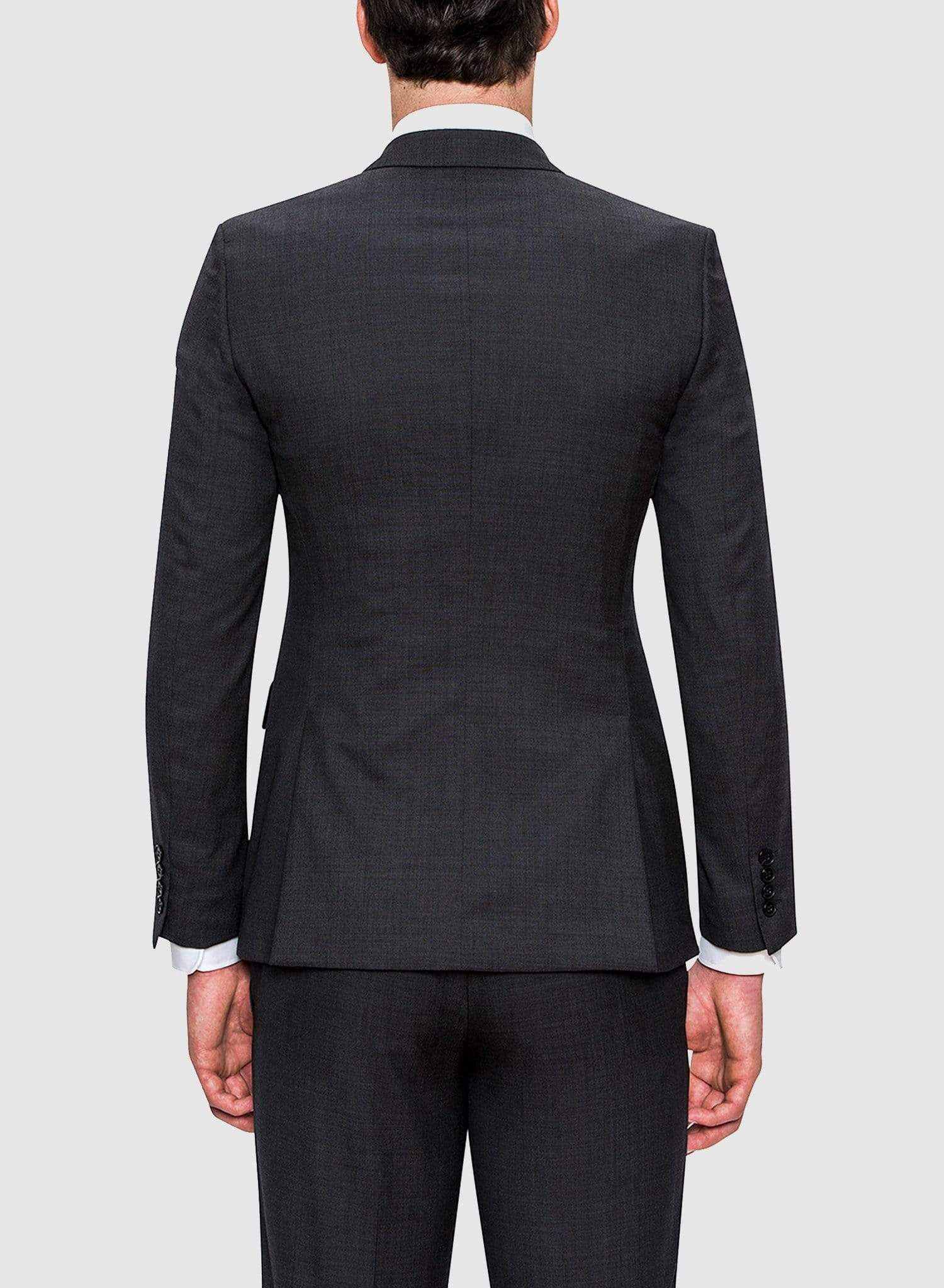 A back view of the A full view of a model wearing the Cambridge classic fit range suit in charcoal pure wool F2800