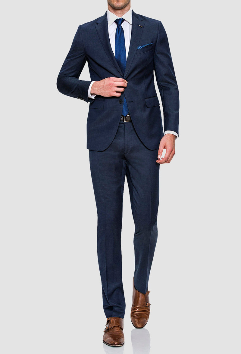 a full length view of a model walking while wearing the Joe Black slim fit razor trouser in blue pure wool styled with a white shirt and blue tie