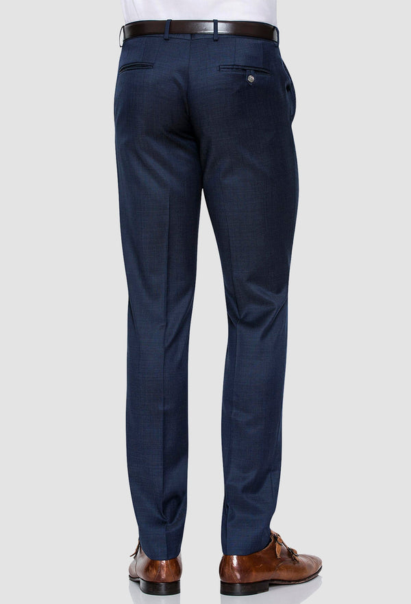 a rear view of the Joe Black slim fit razor trouser in blue pure wool worn by a model with a white shirt