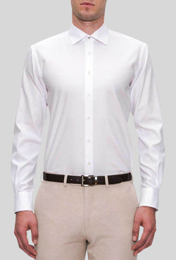 A front on view of the Joe Black slim fit pioneer shirt in white pure cotton FJD044 styled with a beige trouser